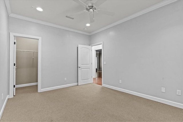 unfurnished bedroom with carpet floors, crown molding, visible vents, and baseboards