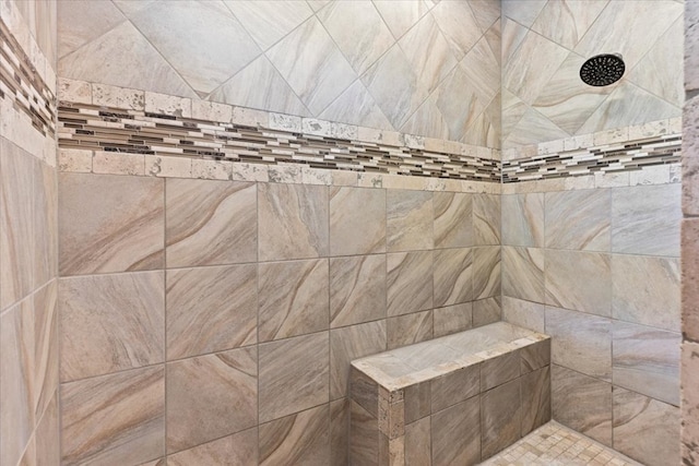 full bath featuring tiled shower
