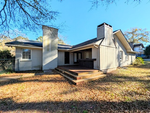 rear view of house featuring a yard