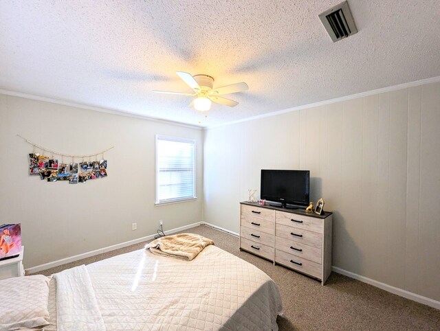 bedroom with carpet, a textured ceiling, ceiling fan, and ornamental molding