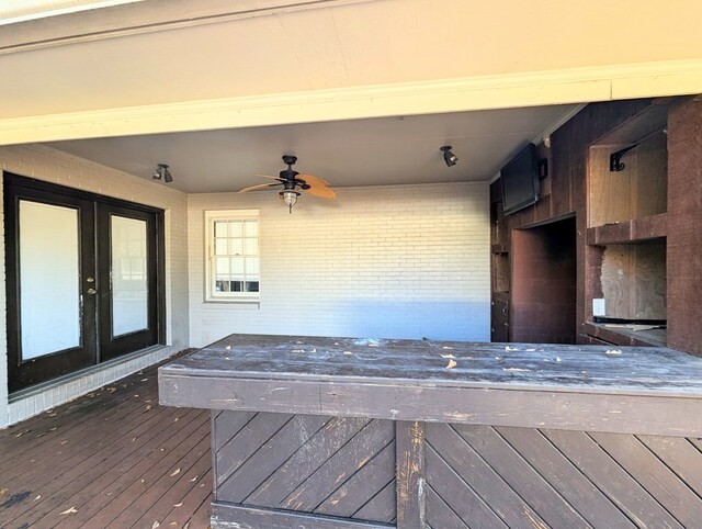 wooden deck featuring ceiling fan and french doors