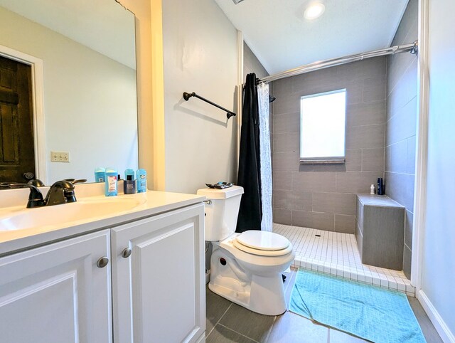 bathroom with curtained shower, vanity, and toilet