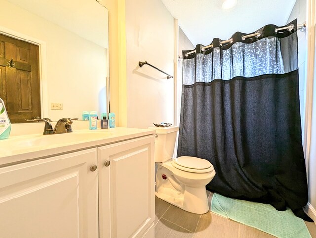 bathroom with wood-type flooring, vaulted ceiling, toilet, vanity, and a shower with shower curtain