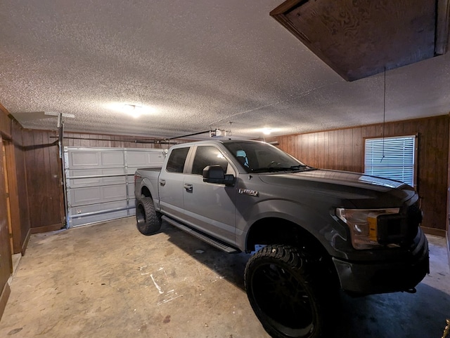 garage featuring wood walls