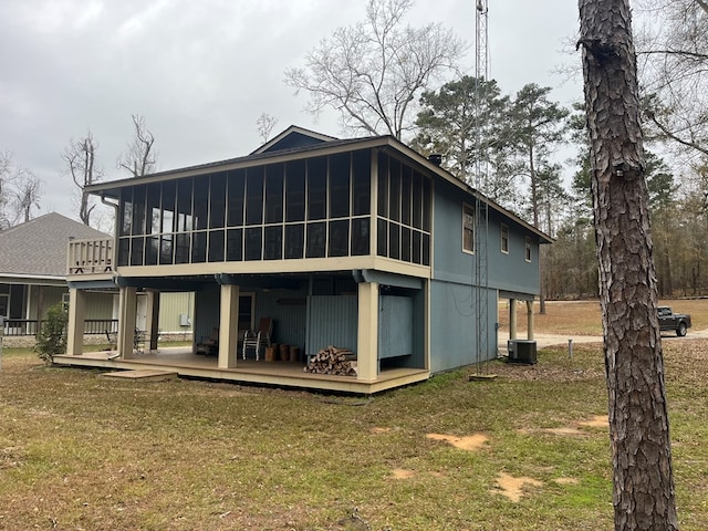 back of house with a sunroom and a yard