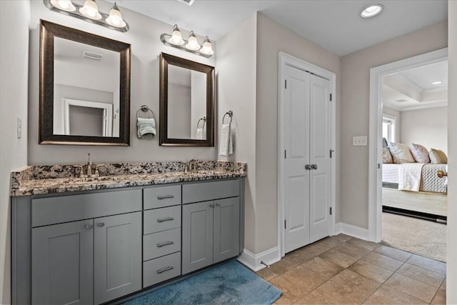 459 Paxton, Dothan, AL 36301 - ensuite bathroom with baseboards, double vanity, a closet, and recessed lighting