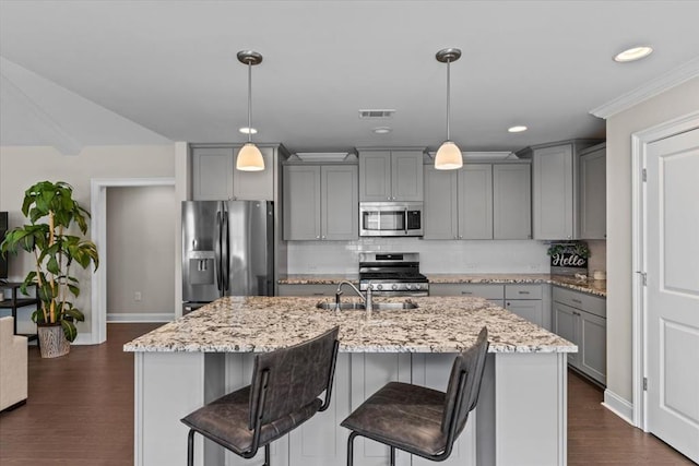 459 Paxton, Dothan, AL 36301 - kitchen with appliances with stainless steel finishes, gray cabinetry, backsplash, light stone counters, and a center island with sink