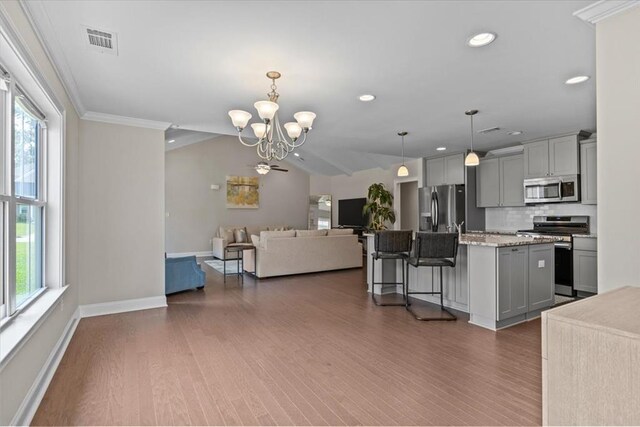 459 Paxton, Dothan, AL 36301 - kitchen with appliances with stainless steel finishes, open floor plan, gray cabinets, wood finished floors, and decorative backsplash