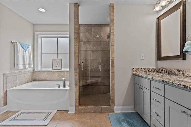 459 Paxton, Dothan, AL 36301 - bathroom featuring vanity, a shower stall, a garden tub, baseboards, and recessed lighting