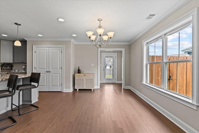 459 Paxton, Dothan, AL 36301 - foyer with a chandelier, dark wood finished floors, baseboards, recessed lighting, and crown molding