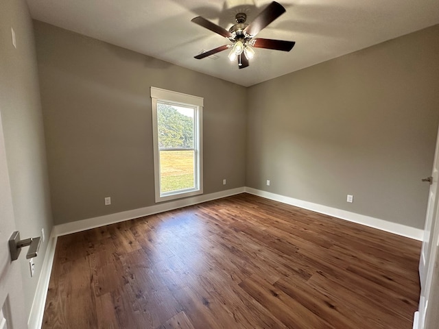 unfurnished room with ceiling fan and dark hardwood / wood-style flooring