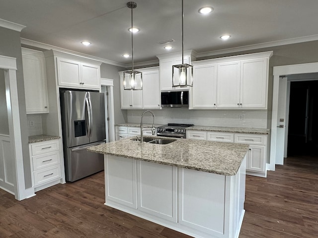 kitchen featuring white cabinets, sink, hanging light fixtures, an island with sink, and stainless steel appliances