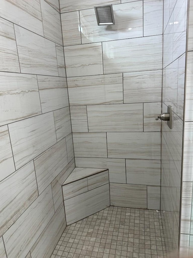 bathroom with a tile shower