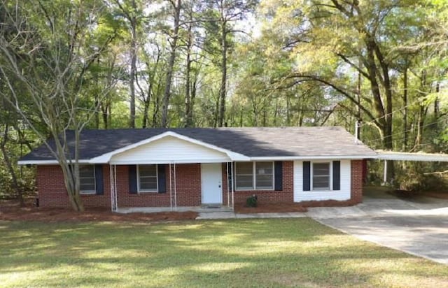 ranch-style house with concrete driveway, a front lawn, brick siding, a porch, and a carport