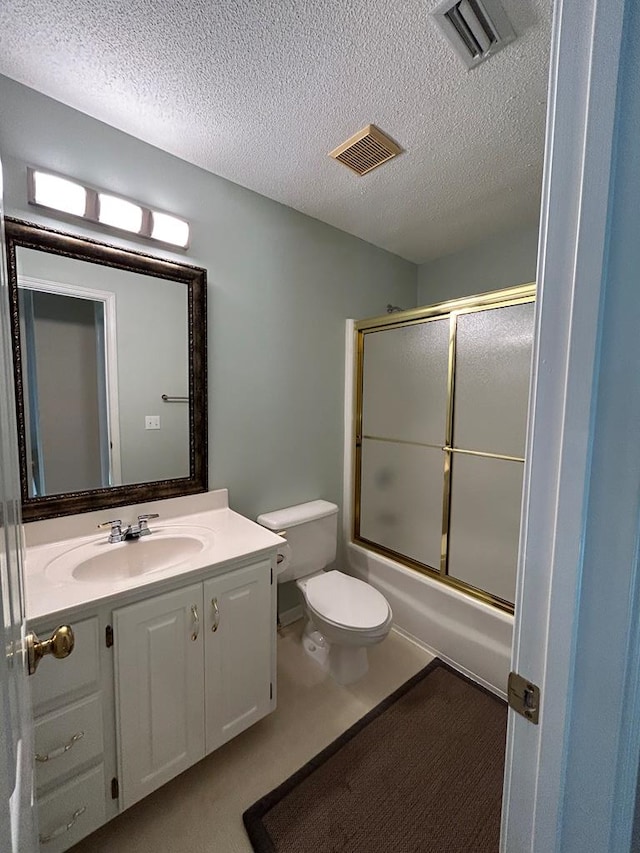 123 Waterford Way, Ashford, AL 36321 - full bath with toilet, vanity, a textured ceiling, and shower / bath combination with glass door