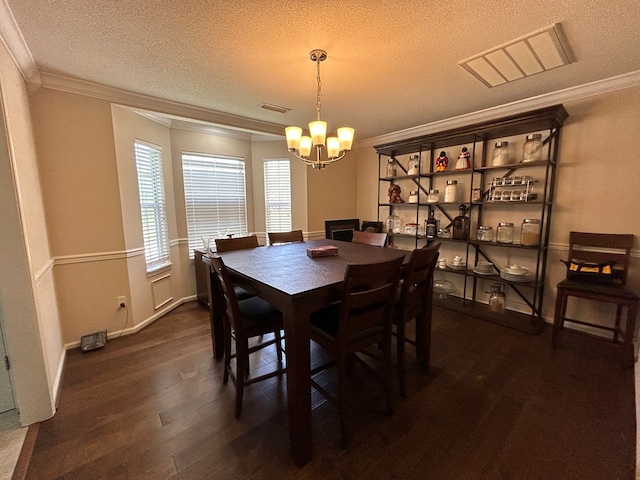 123 Waterford Way, Ashford, AL 36321 - dining area with a textured ceiling, ornamental molding, a chandelier, dark wood finished floors, and baseboards