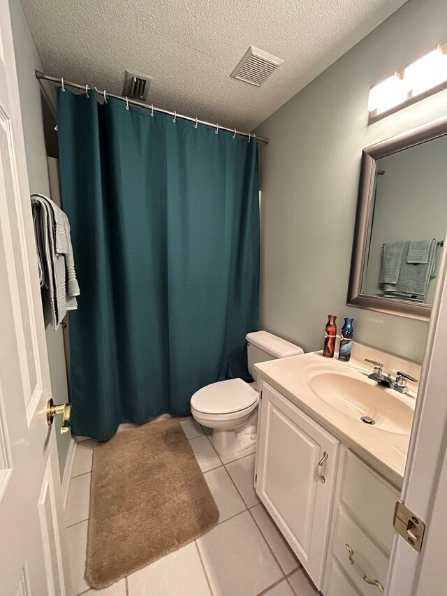 123 Waterford Way, Ashford, AL 36321 - full bath with vanity, toilet, tile patterned floors, a textured ceiling, and a shower with shower curtain