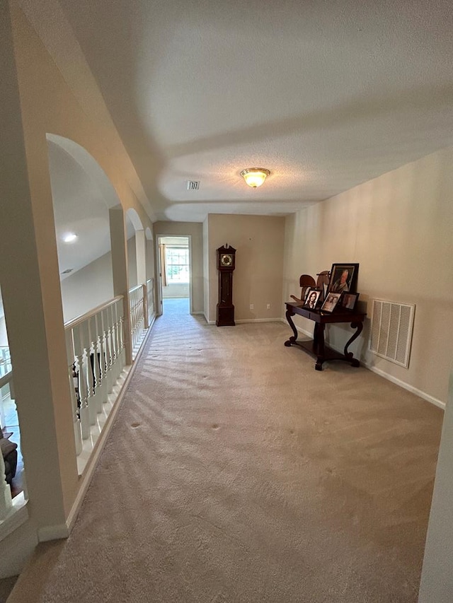 123 Waterford Way, Ashford, AL 36321 - corridor featuring carpet flooring, arched walkways, baseboards, and a textured ceiling