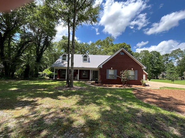 123 Waterford Way, Ashford, AL 36321 - view of front of property featuring a front lawn, concrete driveway, covered porch, and metal roof