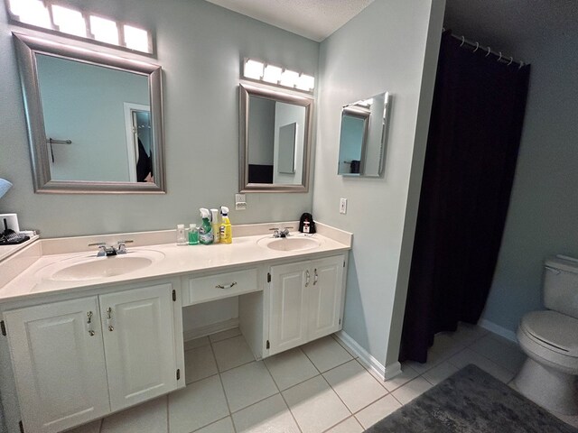 123 Waterford Way, Ashford, AL 36321 - bathroom with toilet, tile patterned floors, double vanity, and baseboards