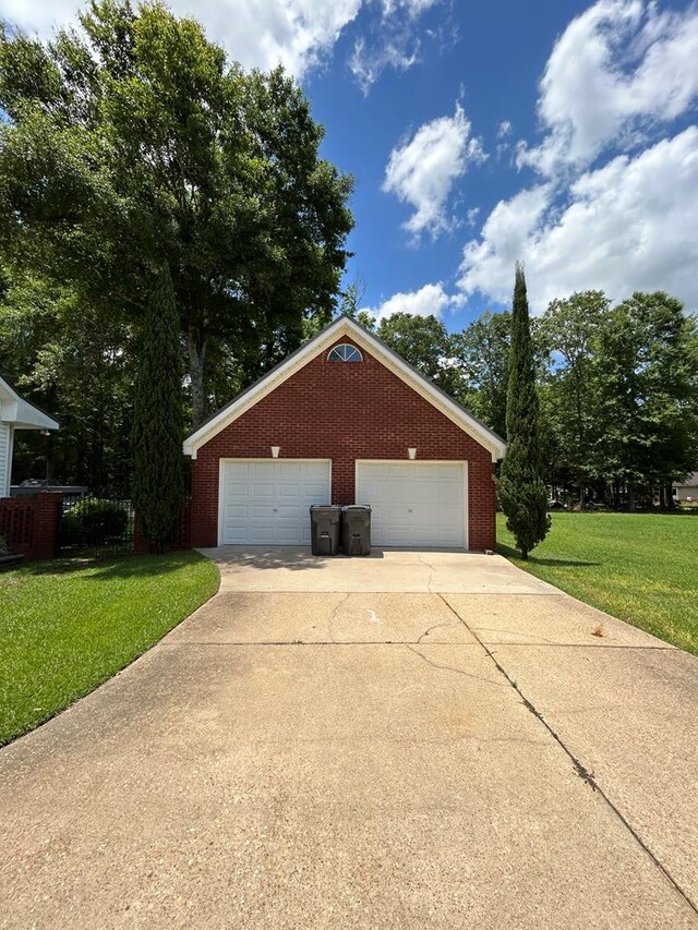 123 Waterford Way, Ashford, AL 36321 - view of side of home with a yard, brick siding, and a detached garage