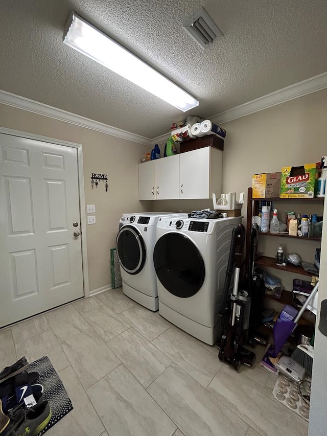 123 Waterford Way, Ashford, AL 36321 - laundry area featuring washing machine and dryer, crown molding, light marble finish flooring, cabinet space, and a textured ceiling