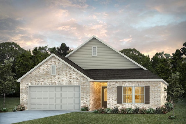 view of front of home featuring a yard and a garage