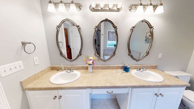 218 Azalea Ln, Headland, AL 36345 - bathroom featuring toilet and double vanity