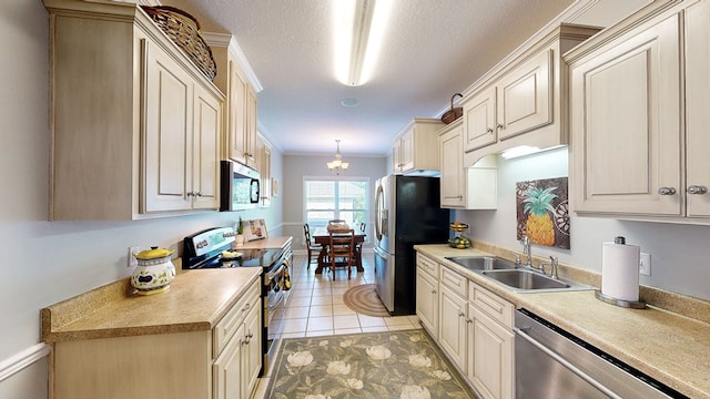 218 Azalea Ln, Headland, AL 36345 - kitchen featuring appliances with stainless steel finishes, a sink, light countertops, crown molding, and a chandelier