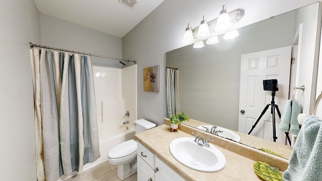 218 Azalea Ln, Headland, AL 36345 - full bath featuring toilet, vanity, wood finished floors, and shower / tub combo