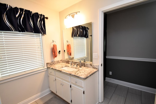 bathroom with baseboards and vanity