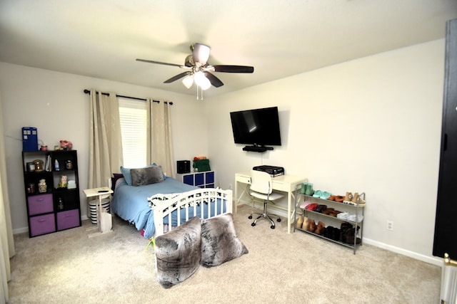 carpeted bedroom with baseboards and a ceiling fan