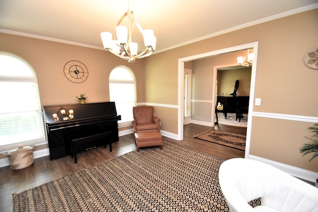 sitting room featuring wood finished floors, baseboards, ornamental molding, and a notable chandelier