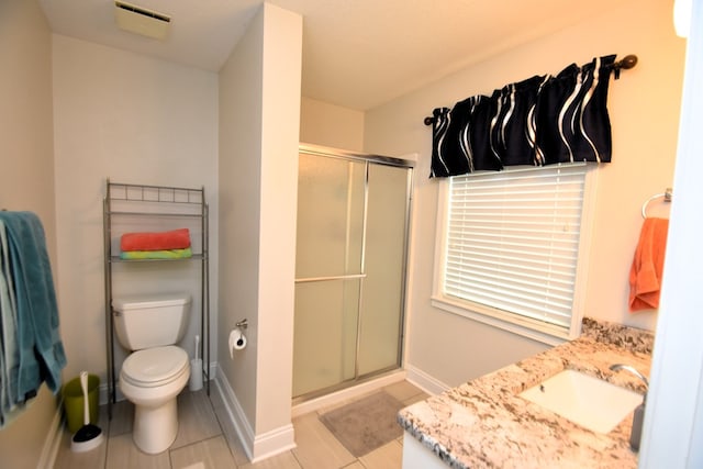 bathroom with tile patterned floors, toilet, baseboards, and a shower stall