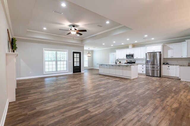212 Archer Trl, Enterprise, AL 36330 - kitchen with open floor plan, appliances with stainless steel finishes, a raised ceiling, ornamental molding, and visible vents