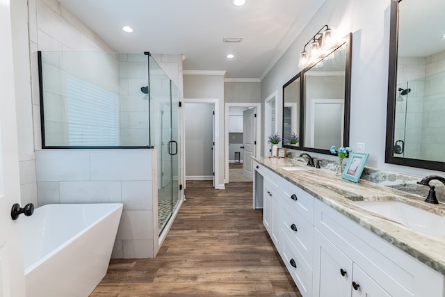212 Archer Trl, Enterprise, AL 36330 - bathroom featuring a shower stall, ornamental molding, wood finished floors, and a sink