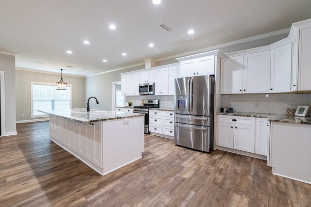 212 Archer Trl, Enterprise, AL 36330 - kitchen featuring tasteful backsplash, wood finished floors, appliances with stainless steel finishes, and ornamental molding
