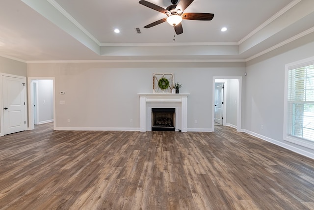 212 Archer Trl, Enterprise, AL 36330 - unfurnished living room featuring a tray ceiling, ceiling fan, ornamental molding, and dark wood-style flooring