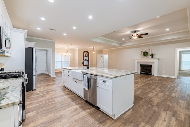 212 Archer Trl, Enterprise, AL 36330 - kitchen with ornamental molding, baseboards, appliances with stainless steel finishes, white cabinetry, and ceiling fan with notable chandelier