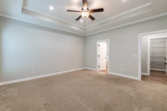 212 Archer Trl, Enterprise, AL 36330 - unfurnished bedroom featuring crown molding, a walk in closet, a tray ceiling, carpet, and baseboards