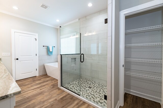 212 Archer Trl, Enterprise, AL 36330 - bathroom featuring a shower stall, wood finished floors, visible vents, crown molding, and a soaking tub