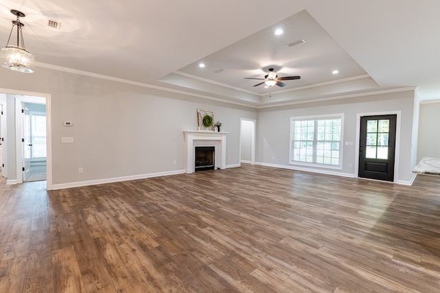 212 Archer Trl, Enterprise, AL 36330 - unfurnished living room featuring a raised ceiling, visible vents, dark wood-type flooring, crown molding, and ceiling fan