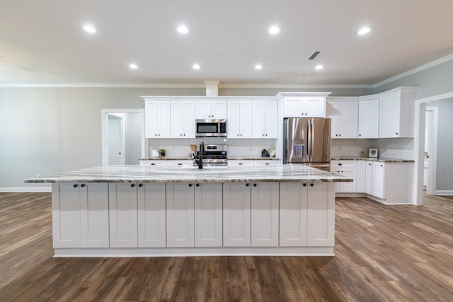 212 Archer Trl, Enterprise, AL 36330 - kitchen featuring a large island, white cabinetry, tasteful backsplash, appliances with stainless steel finishes, and dark wood-style flooring