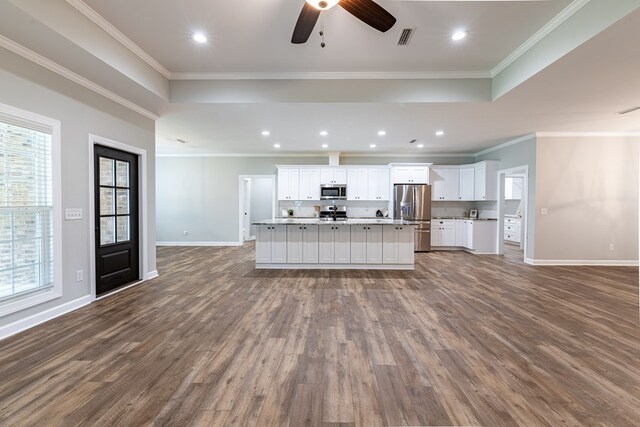 212 Archer Trl, Enterprise, AL 36330 - kitchen featuring open floor plan, stainless steel appliances, dark wood-type flooring, and a raised ceiling