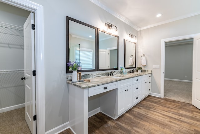 212 Archer Trl, Enterprise, AL 36330 - bathroom with a walk in closet, double vanity, baseboards, and ornamental molding