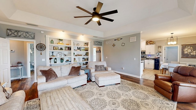 201 W Azalea Ln, Headland, AL 36345 - living area with a ceiling fan, wood finished floors, ornamental molding, and a chandelier