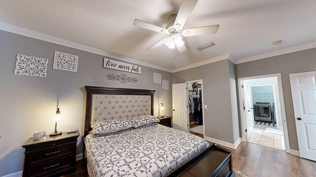 201 W Azalea Ln, Headland, AL 36345 - bedroom with ornamental molding, wood finished floors, a walk in closet, ceiling fan, and a closet
