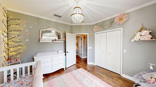 201 W Azalea Ln, Headland, AL 36345 - bedroom featuring a chandelier, wood finished floors, ornamental molding, and a closet