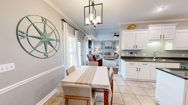 201 W Azalea Ln, Headland, AL 36345 - kitchen featuring dark countertops, crown molding, decorative light fixtures, white cabinets, and a chandelier