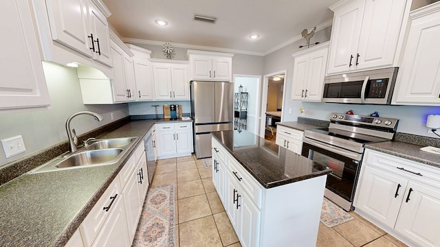201 W Azalea Ln, Headland, AL 36345 - kitchen with stainless steel appliances, crown molding, white cabinetry, light tile patterned floors, and recessed lighting